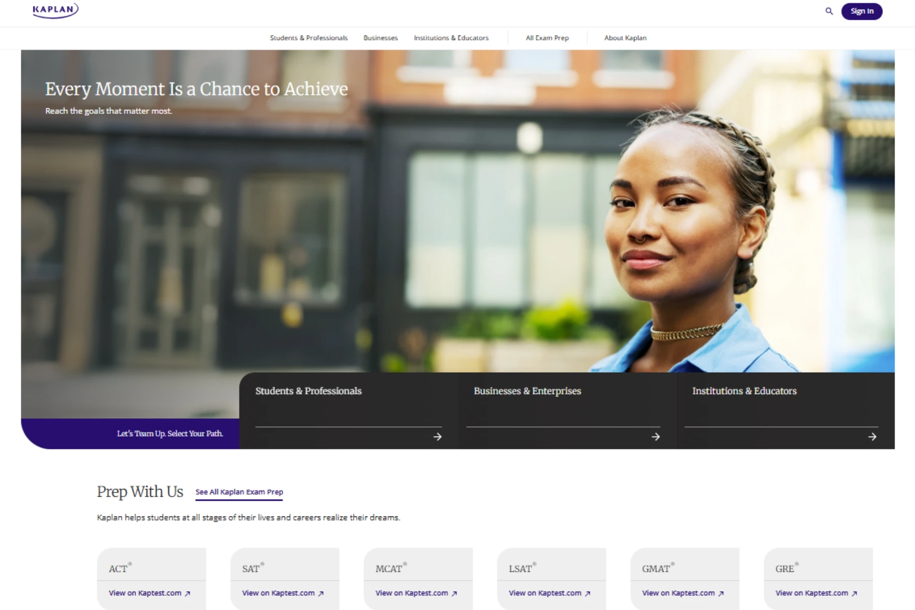 Kaplan homepage with “Every Moment Is a Chance to Achieve” hero banner, student photo, and exam prep links.