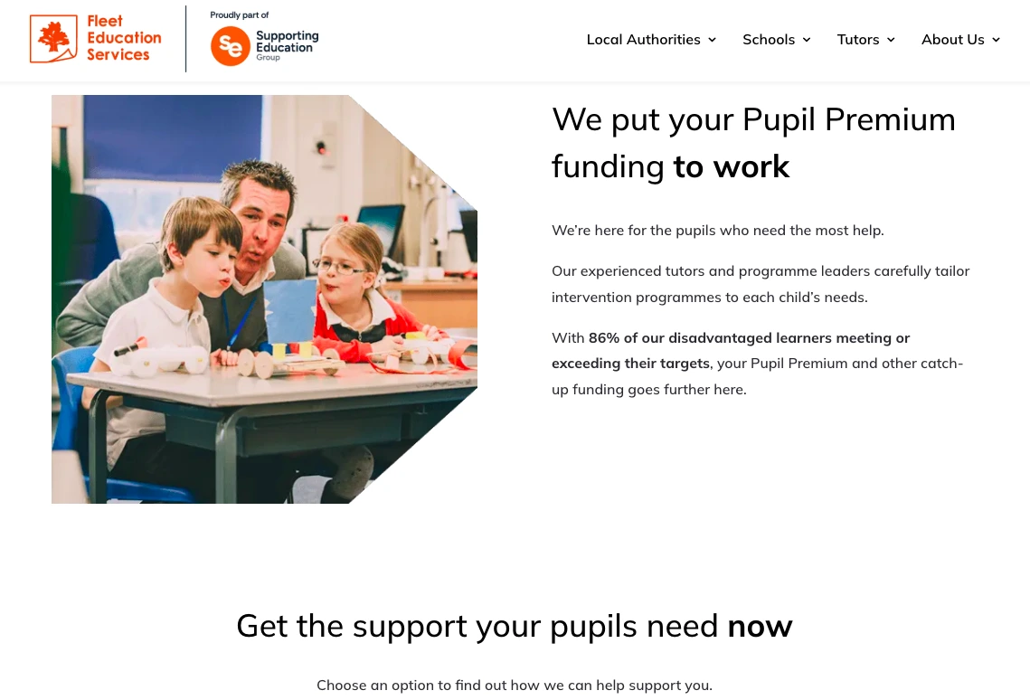 Teacher assisting two primary school students with hands-on learning activity in a classroom supported by Fleet Education Services